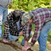 David Ledbetter and Doug Tipton nail two locust poles together to form the border for the walkway.