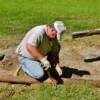 J.T. Tipton nails locust timbers together to form a border for the new walkway.